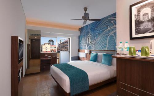 a hotel room with a bed and a television at ibis Styles Goa Calangute - An Accor Brand in Calangute