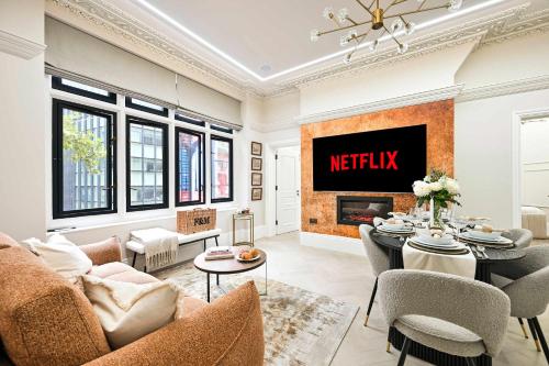 a living room with a meisel sign on the wall at 3 Bed Flat-Zone 1-Totthenham Court Rd-Luxury-Families-Groups-Professionals in London