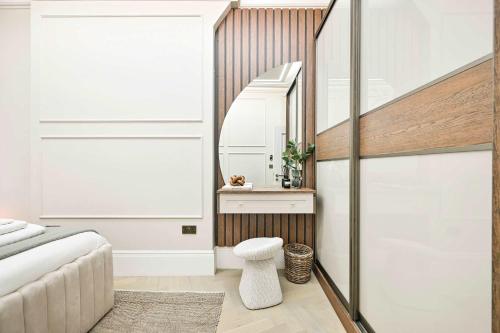 a bedroom with a stairway leading up to a room with white walls at 3 Bed Flat-Zone 1-Totthenham Court Rd-Luxury-Families-Groups-Professionals in London