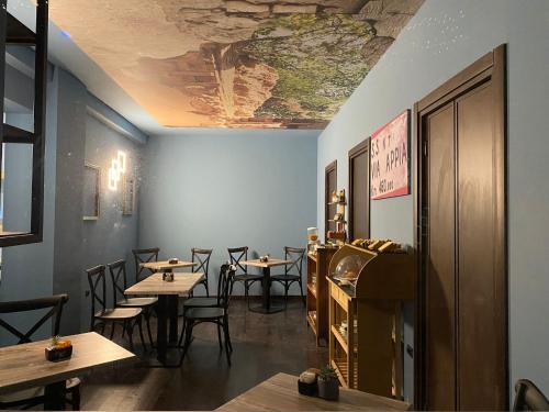 a restaurant with tables and chairs and a ceiling at Pretoria Potenza in Potenza
