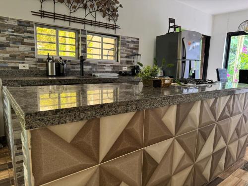 a kitchen with a granite counter top in a room at Finca Casa Mercedes rivera in Rivera