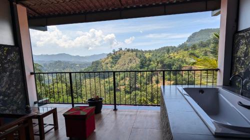 a bathroom with a tub and a view of the mountains at Rainbow Sky Cottage in Ella