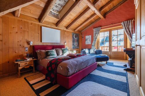 a bedroom with a large bed in a room with wooden walls at Magic Megève Bois in Demi-Quartier