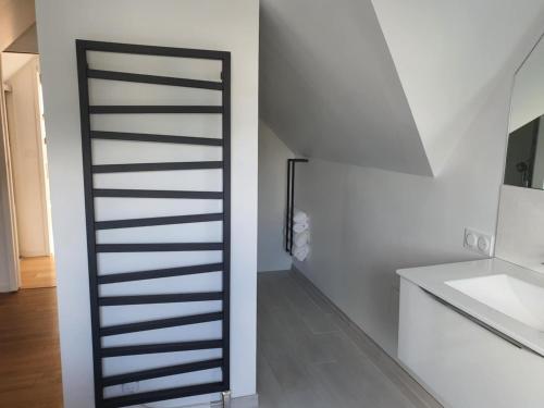 a staircase in a white room with a sink at Maison De Campagne Proche de La Mer in Brandérion
