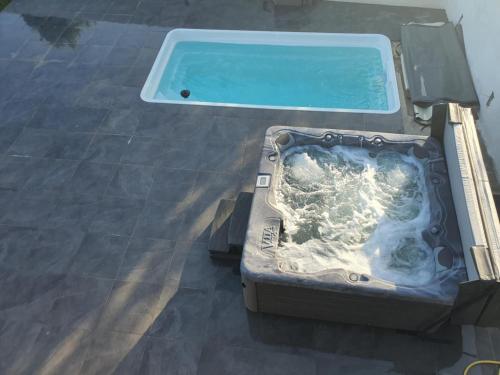 an open suitcase with a pool on the floor at Maison De Campagne Proche de La Mer in Brandérion