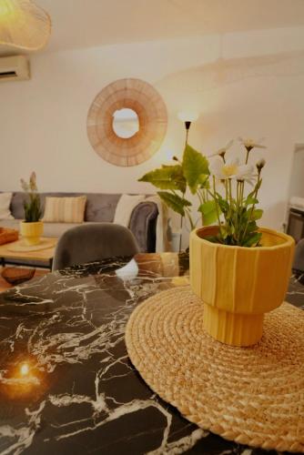 a vase with flowers on a table in a living room at Cozy Detached Home 7 Guests in Podgorica
