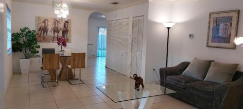 a living room with a couch and a table at Room 5 minutes from PBI Airport in West Palm Beach