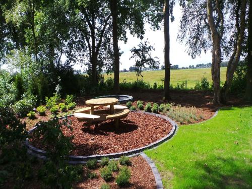 a picnic table in the middle of a garden at Holiday Home near Sallandse Heuvelrug in Lemele