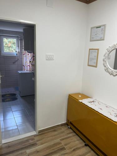 a room with a bed and a mirror on the wall at Verica 2025 in Vrdnik