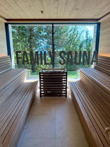 a row of benches in a room with a large window at Tratterhof Mountain Sky Hotel in Maranza