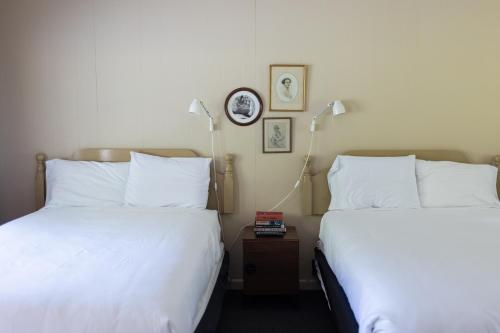 two beds sitting next to each other in a hotel room at The Little Lion in Great Barrington