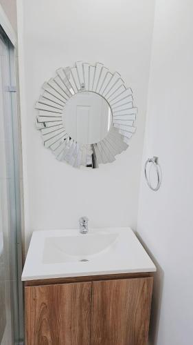a bathroom with a sink and a mirror on the wall at Tu espacio ideal en Intercity Urban Corridor in Querétaro