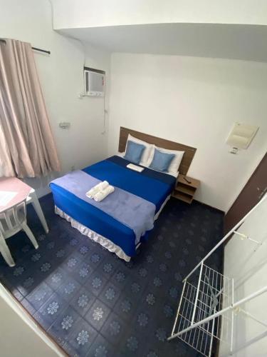 a hotel room with a bed and a table at Vale do Pontal Angra Suites in Angra dos Reis