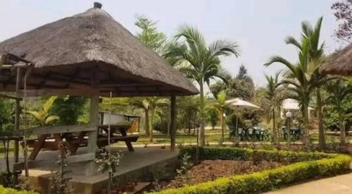 a gazebo with a table and a grill at Mutanda Georgie's Bar & Grill in Mutanda