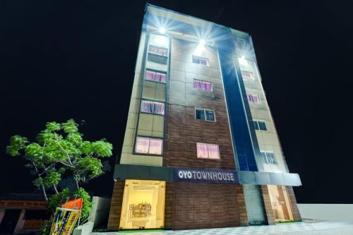 a tall building with lights on top of it at Super Townhouse La Vista in Rānchī