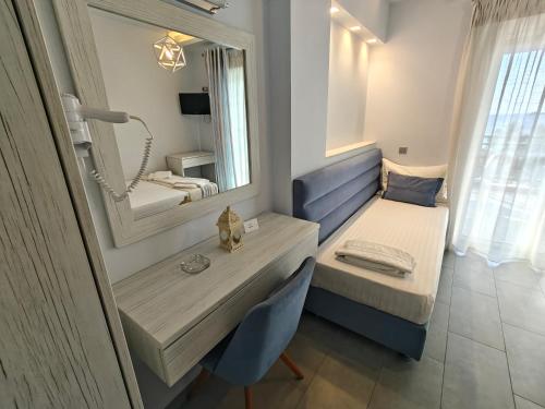 a bathroom with a sink and a mirror at Studios Apollon in Chrysi Ammoudia