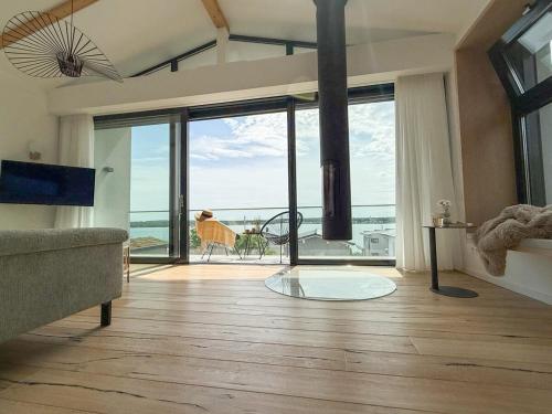 a living room with a view of the ocean at Ava Lodge am Hainer See in Neukieritzsch