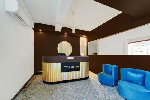 a meeting room with blue chairs and a podium at Super Townhouse OAK The Dev Regency in Patna