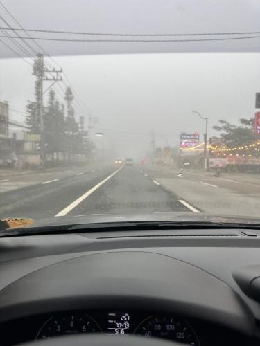 a view from a car windshield of a highway at Yna's Place - SMDC Tagaytay in Galicias