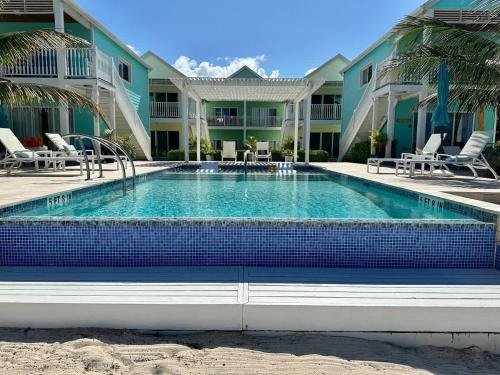 a swimming pool in front of a building at The One Love at Cottages in Sand Bluff