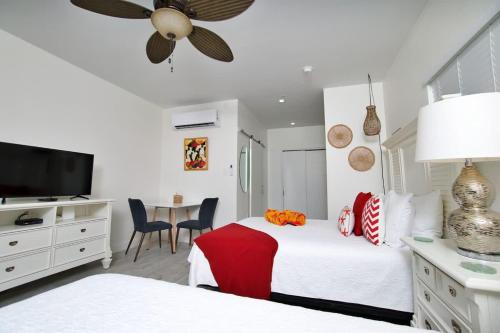 a bedroom with two beds and a flat screen tv at The No Problem at Cottages in Sand Bluff