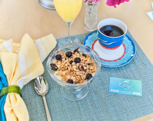 a table with a bowl of granola and a cup of coffee at The No Problem at Cottages in Sand Bluff