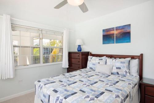 a bedroom with a bed and a window at Snug Harbour View Condo #7 in George Town