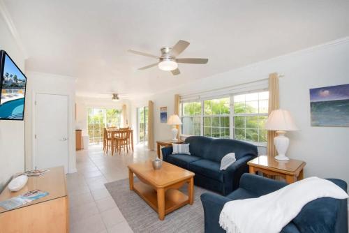 a living room with a blue couch and a table at Snug Harbour View Condo #6 in George Town
