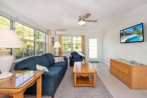 a living room with a blue couch and a table at Snug Harbour View Condo #6 in George Town