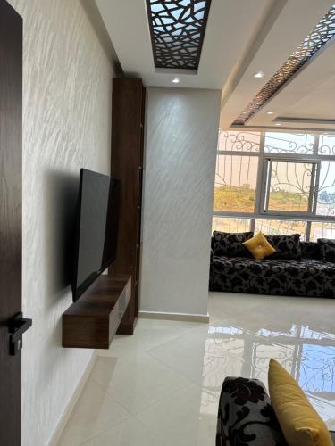 a living room with a flat screen tv on a wall at Villa Kenitra in Kenitra