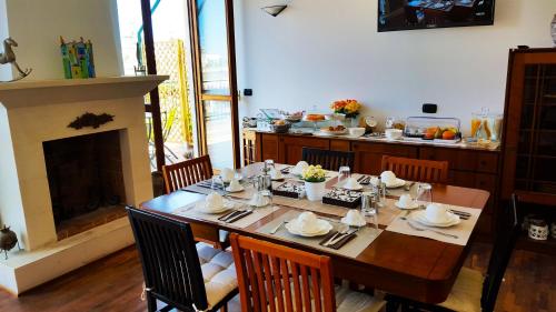 a dining room with a table and a fireplace at Attico Barocco in Lecce