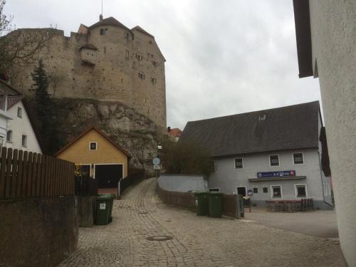 a castle sitting on top of a hill next to buildings at Zur Krone in Wolfsegg