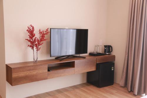 a flat screen tv sitting on top of a wooden entertainment center at Soleil Urban Villa in Hue
