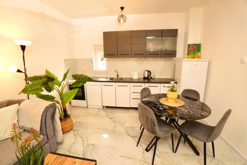 a kitchen and dining room with a table and chairs at Cozy Detached Home 7 Guests in Podgorica