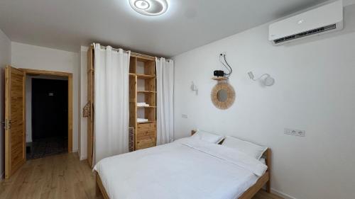 a bedroom with a white bed and a closet at Затишне місце біля парку in Kyiv