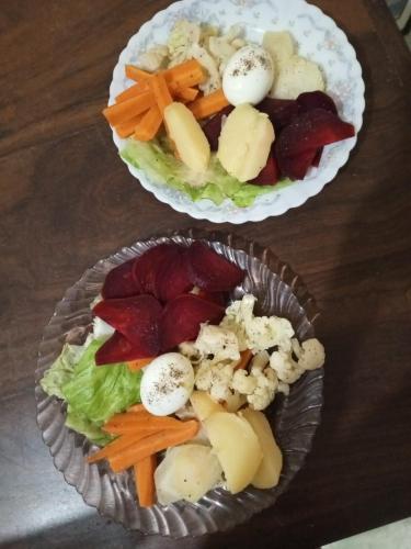 two plates of food with vegetables on a table at Water Front Home Stay and Resort in Anuradhapura