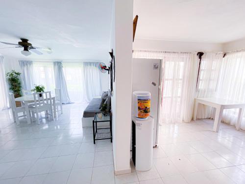 a living room with a refrigerator and a table at LOS CORALES Resort VILLAS & Apartments WIFI BEACH Club & SPA in Punta Cana