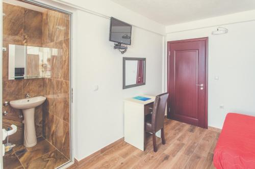 a bathroom with a shower and a sink and a toilet at David apartments and rooms in Dobra Voda
