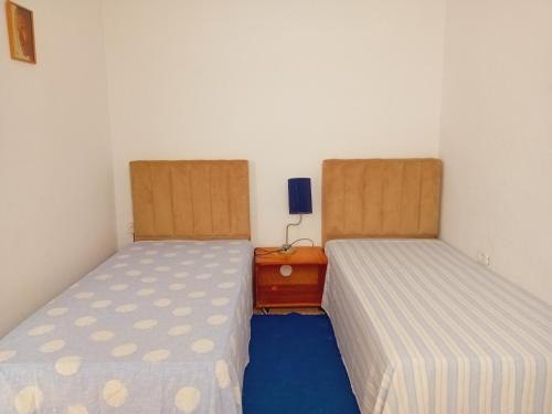 two beds sitting next to each other in a room at chez chayma in Dar Tahar Zaouch