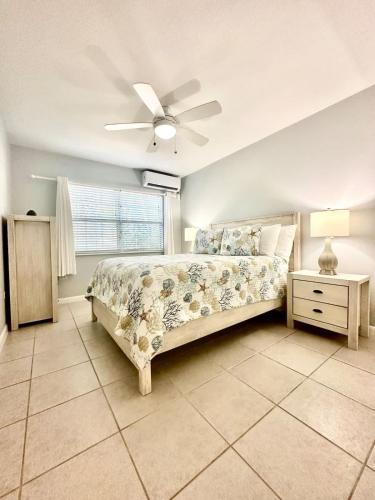 a bedroom with a bed and a ceiling fan at Snug Harbour View Condo #4 in George Town