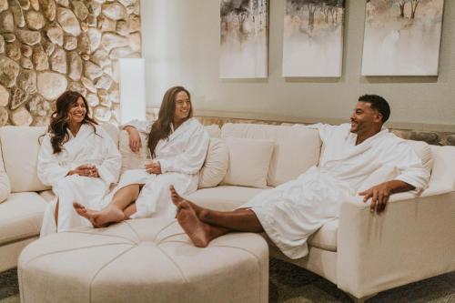 three people in white robes sitting on a couch at Grand Traverse Resort and Spa in Traverse City