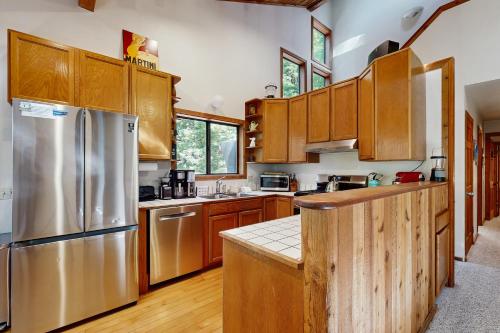 a kitchen with wooden cabinets and stainless steel appliances at Sequoia Sunset in Gualala
