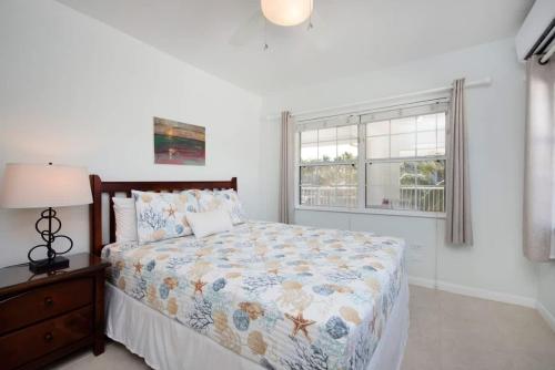 a bedroom with a bed and a window at Snug Harbour View Condo #9 in George Town
