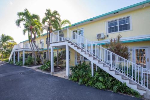a house with a white staircase in front of it at Snug Harbour View Condo #9 in George Town