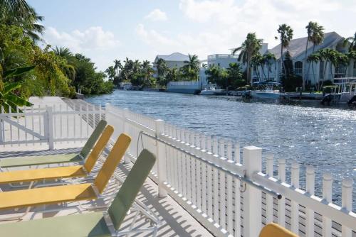 a group of chairs sitting on the side of a river at Snug Harbour View Condo #9 in George Town