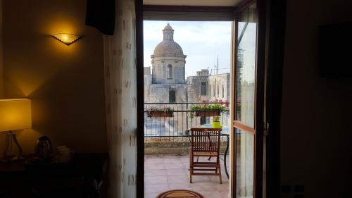 a view of a building from a room with a window at Attico Barocco in Lecce