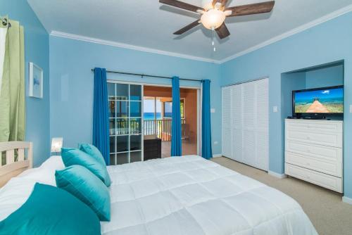 a blue bedroom with a bed and a ceiling fan at Northern Lights #4 Condo in Old Man Bay