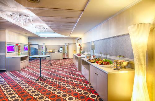 a large kitchen with a red and white floor at Leonardo Hotel Munich Arabellapark in Munich