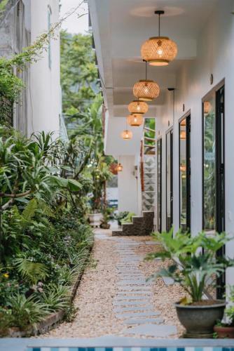 a hallway of a building with plants and lights at TamCoc My Tho Homestay in Vũ Lâm