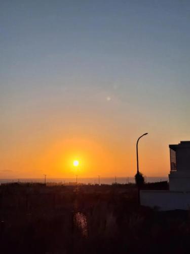 a sunset in a field with a street light at Harmonious Villa in Flic-en-Flac with Private Pool in Flic-en-Flac